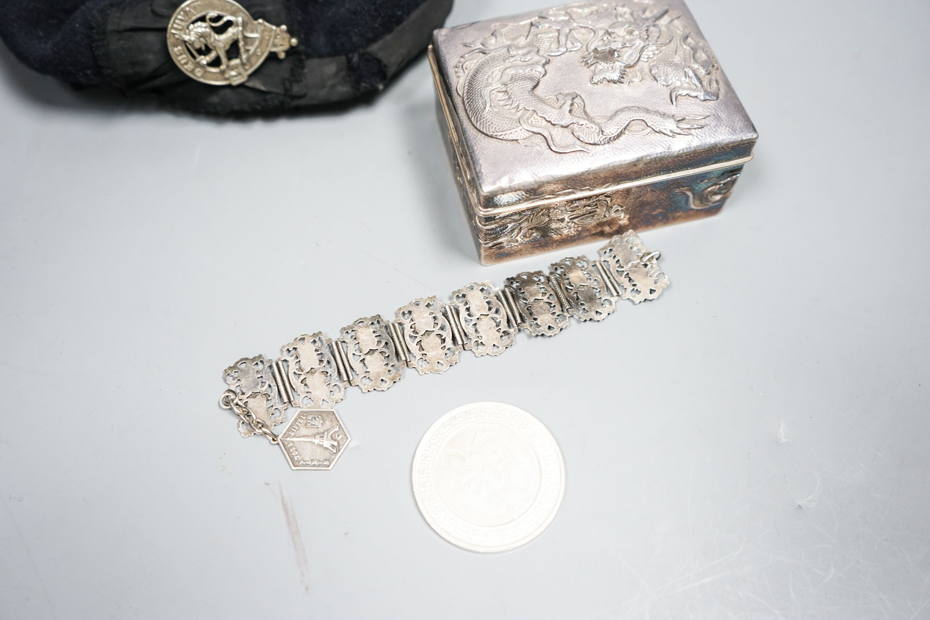 A Japanese silver box, bracelet, medal and military cap